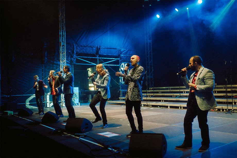 A cappella singing group Accent performs on stage.