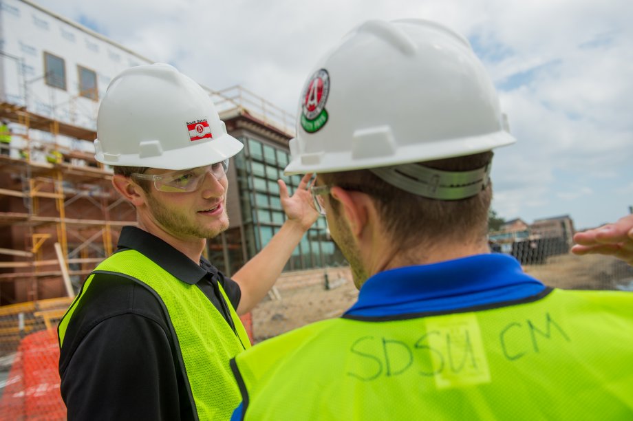 Construction students outside AME building project.