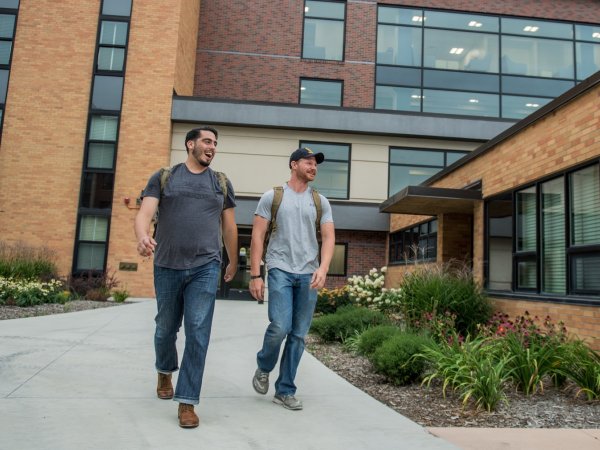 Two students walking by the VARC.