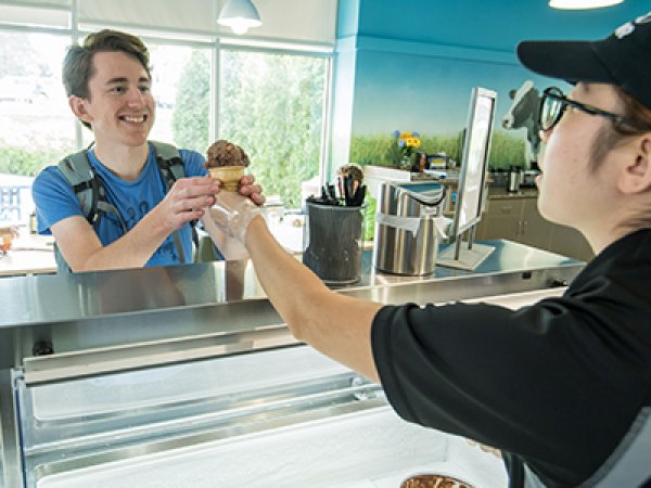 Student ordering an icecream cone at the SDSU Dairy Bar