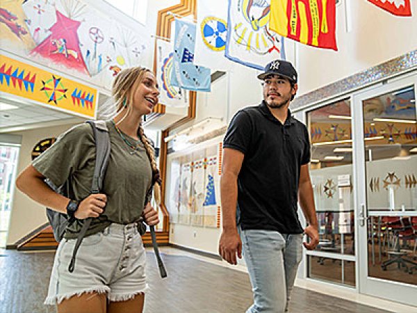 Two students walking in the American Indian Center