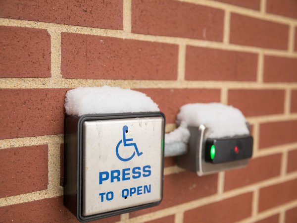 power door opener placed on building covered with light snow