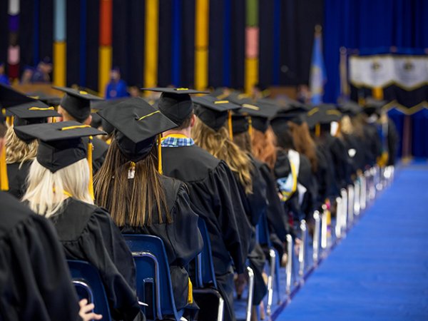 Rows of graduates at a commencement ceremony.