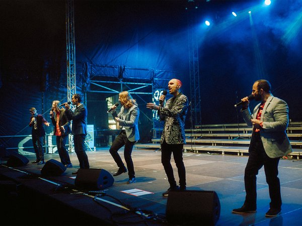 A cappella singing group Accent performs on stage.