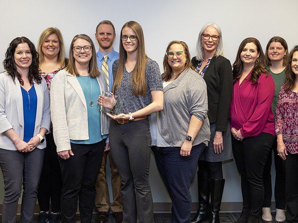 Staff of the Population Health Evaluation Center at South Dakota State University gather with South Dakota Department of Health representatives after the center was named the department's 2023 outstanding Partner in Health for the work the center does to support the department.