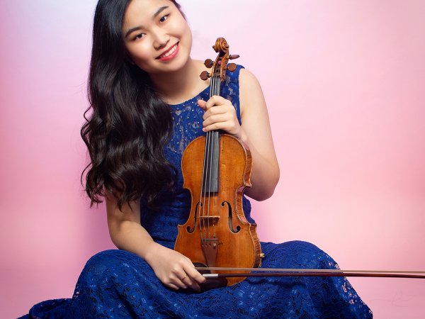 Musician SooBeen Lee holding a violin.