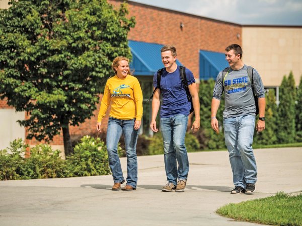 Three student walking on campus