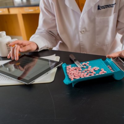 Pharmacy student counting pills