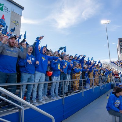 Students cheering for the Jackrabbit football team at Dykhouse Stadium.