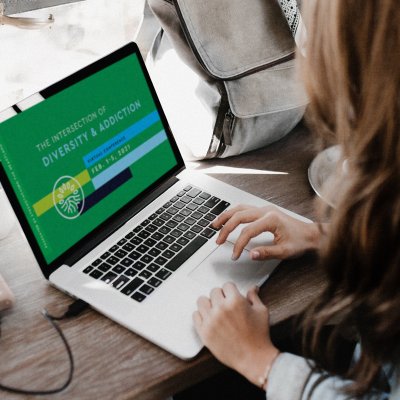 Woman on Laptop looking at conference graphic