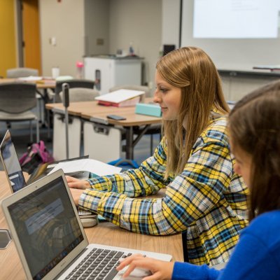 Pharmacy students work on laptops