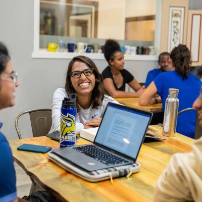 Three students sitting at a table studying together.