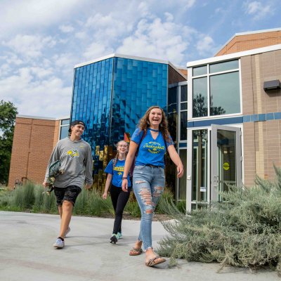 Students walking out of a building.