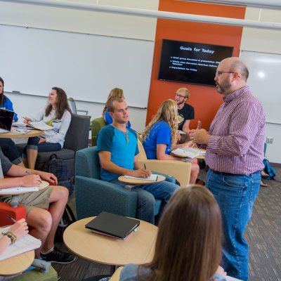 Professor teaching in a classroom full of students 