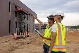 Two individuals looking at a construction jobsite.