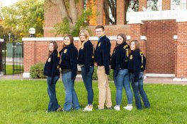 Students standing in a group showing their FFA jackets.
