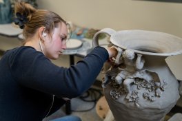 Student working in a ceramics studio.
