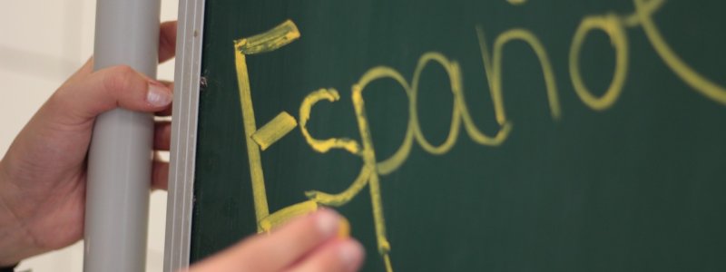 View of a board with Espanol written on it.