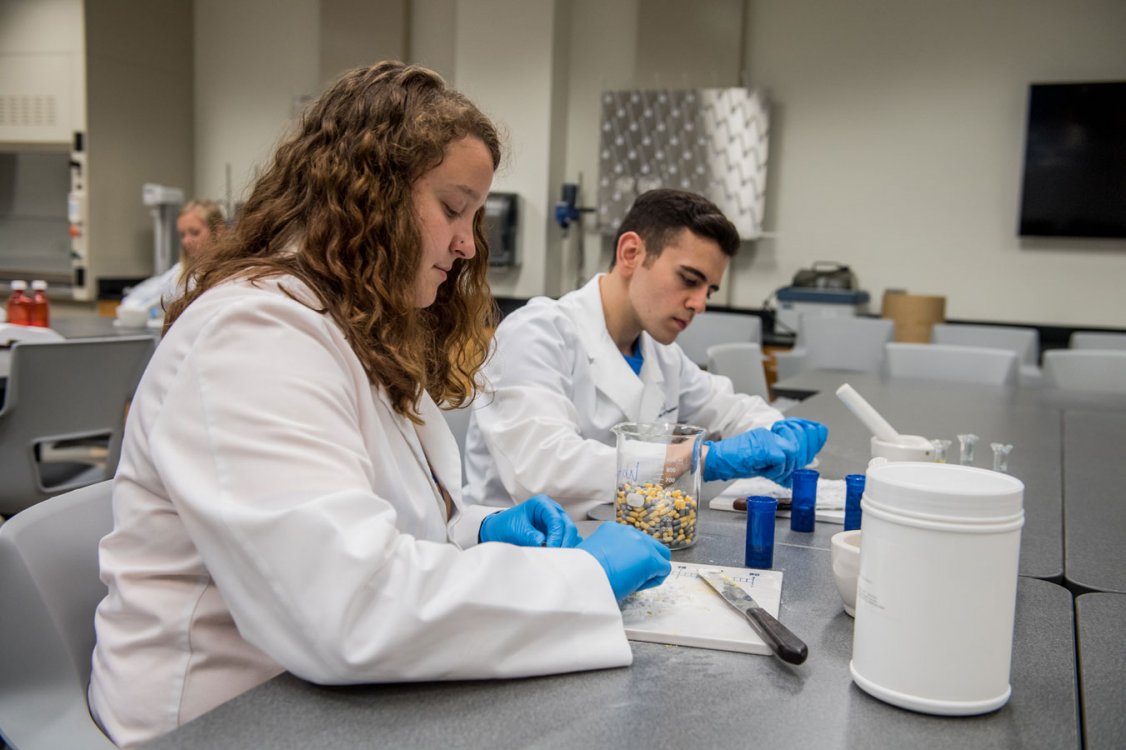 Pharmacy students compounding medications