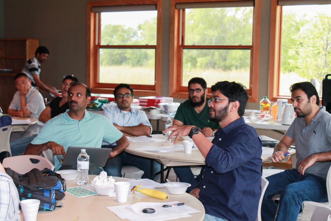 students and faculty at a table