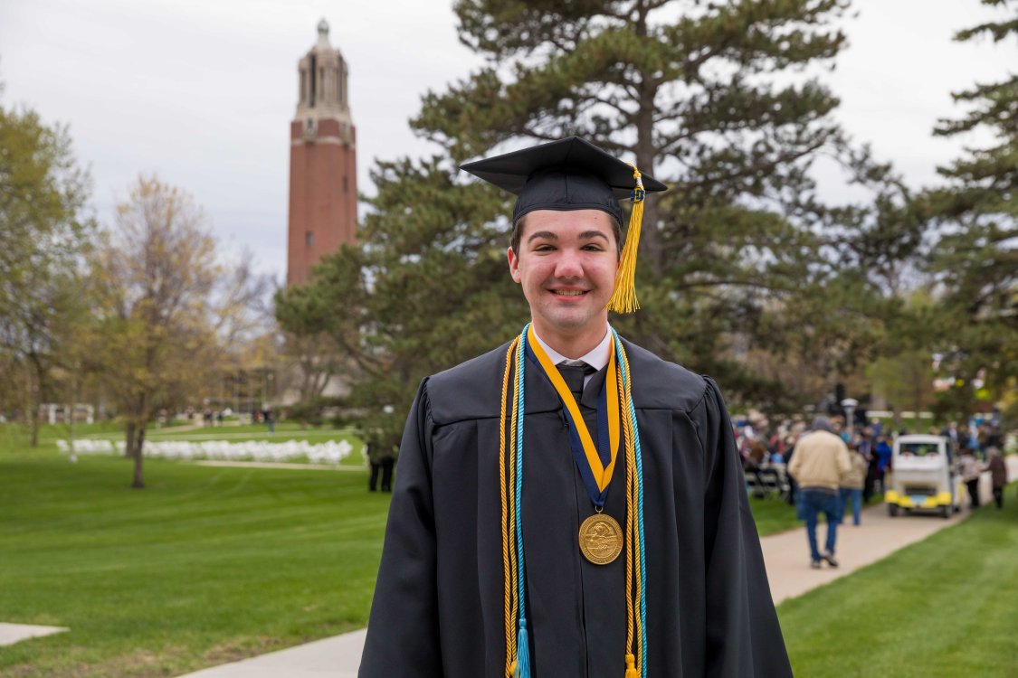 Student in Graduation Cap and Gown by Campanile