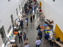 Visitors talk with students presenting their projects during the 2023 Engineering Expo at the Raven Precision Agricultural Center.