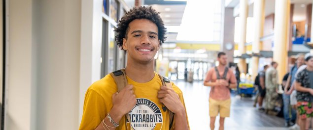 Student standing on mainstreet at the Student Union