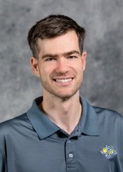 Filip Viskupic poses in front of grey background