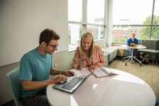 Student and instructor looking at a laptop