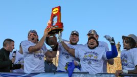 Players from the 2022 FCS Championship team yelling and holding the NCAA trophy in the air.