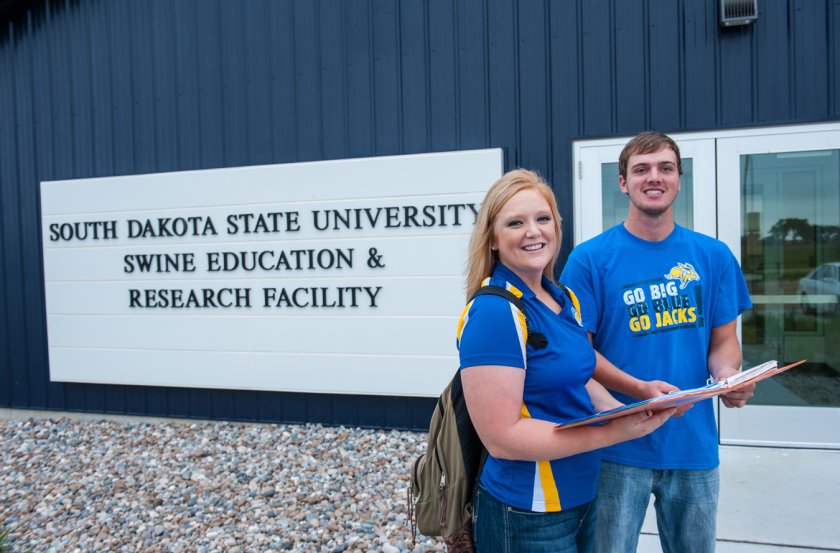 Students standing in front of the swine unit