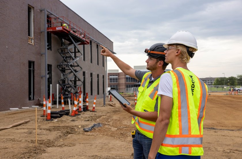 Two individuals looking at a construction jobsite.