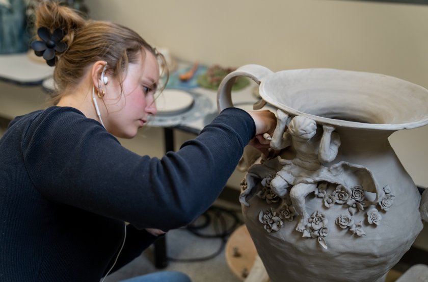 Student working in a ceramics studio.