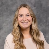 Girl with blonde hair in front of grey background