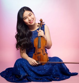 Musician SooBeen Lee holding a violin.